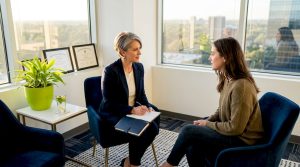 Psychiatrist consulting with patient in office