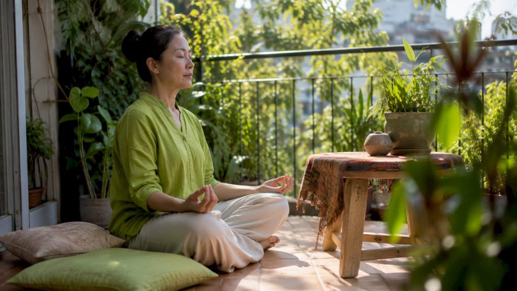 Woman meditating in bright living room