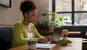 Person preparing telehealth mental health session at home desk