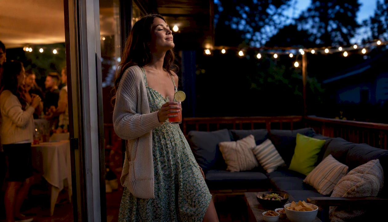 Young woman taking a calming break outside party