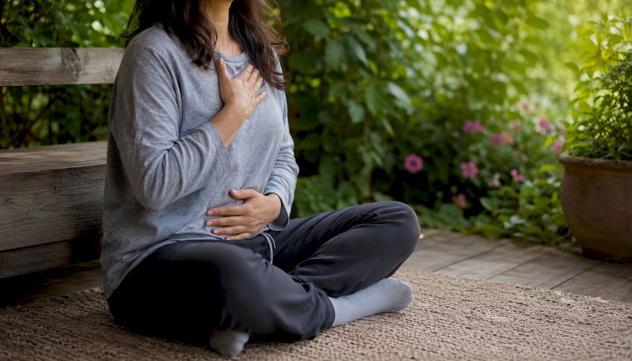 Person practicing diaphragmatic breathing posture