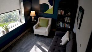 Empty psychiatric evaluation room with armchair and desk