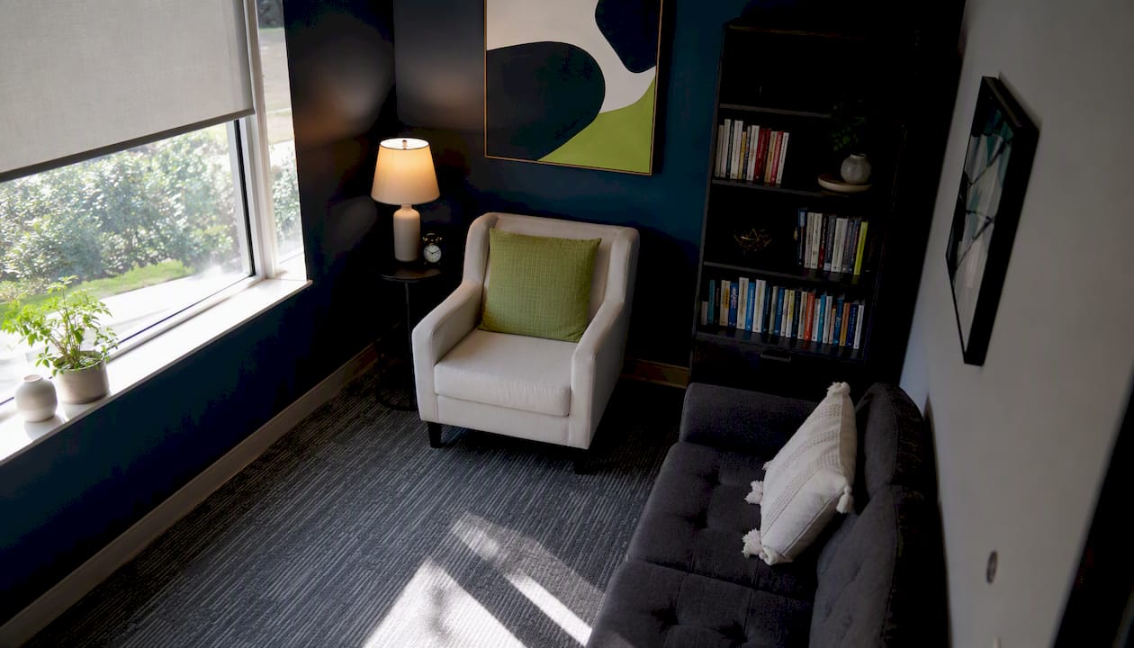 Empty psychiatric evaluation room with armchair and desk