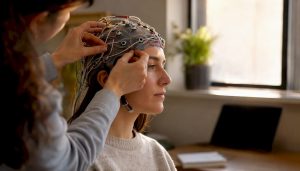 Hands adjusting EEG cap for brain study