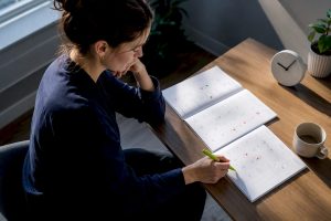 Woman tracking ADHD symptoms across cycles