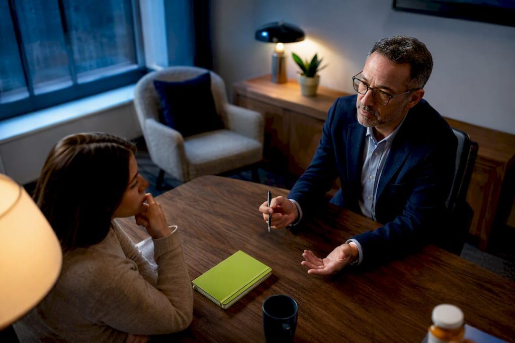 Psychiatrist discussing medication augmentation with patient