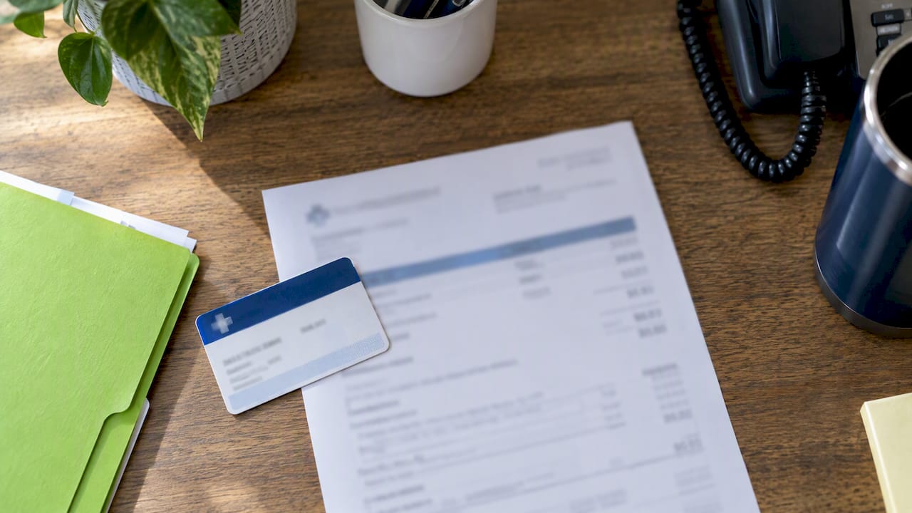 Insurance card beside a psychiatry visit estimate